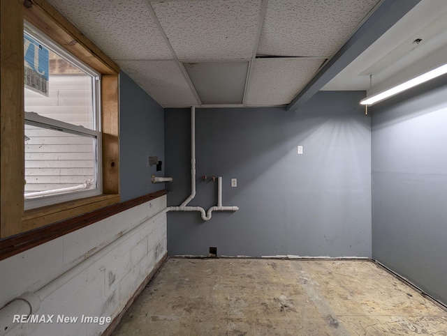 basement with a paneled ceiling