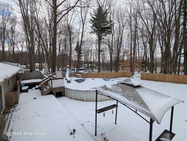 snowy yard featuring a deck