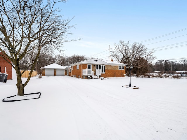 yard layered in snow featuring a garage