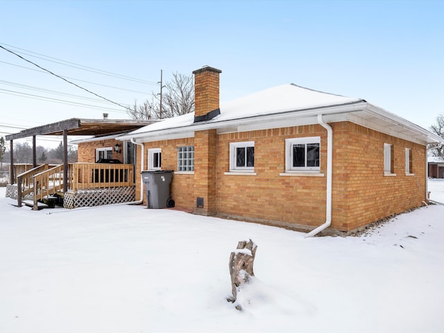 snow covered property featuring a wooden deck