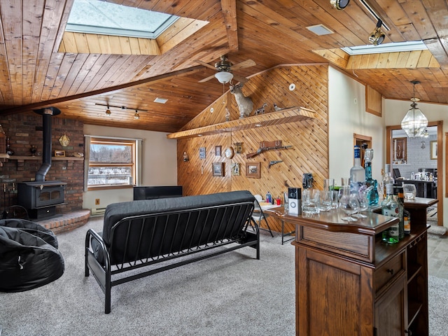 bedroom with wood ceiling, wood walls, a wood stove, and carpet flooring