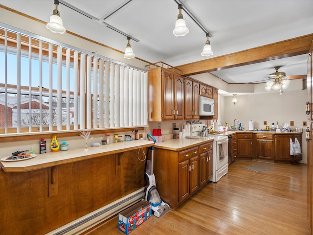 kitchen featuring decorative light fixtures, ceiling fan, white appliances, and light hardwood / wood-style floors