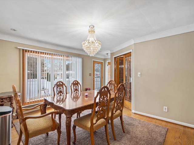 dining room with a notable chandelier and light hardwood / wood-style floors