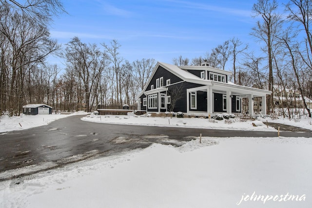 exterior space with covered porch and a garage