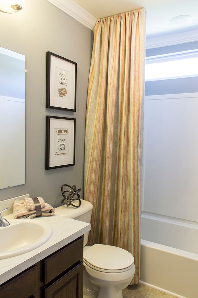 full bathroom with tile patterned floors, vanity, shower / tub combo, toilet, and crown molding