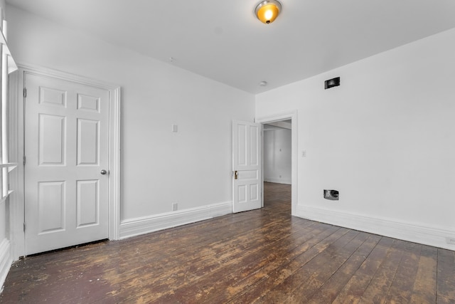 unfurnished bedroom with dark hardwood / wood-style flooring