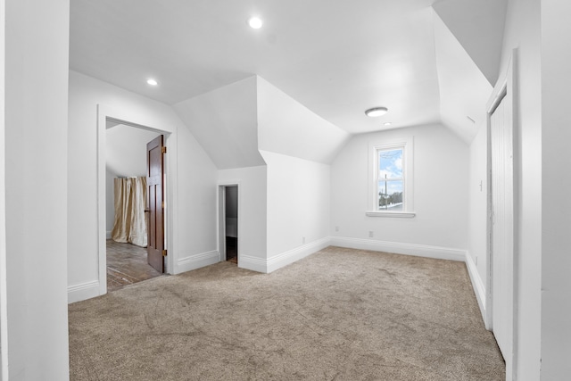 bonus room featuring vaulted ceiling and carpet floors