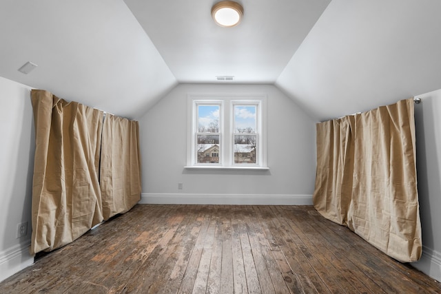 additional living space featuring dark hardwood / wood-style floors and vaulted ceiling