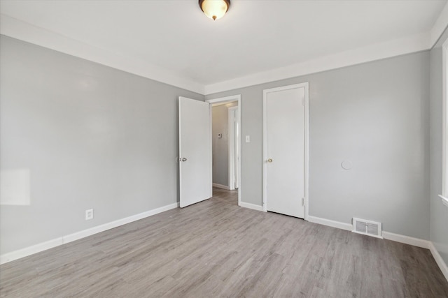 spare room with light hardwood / wood-style flooring