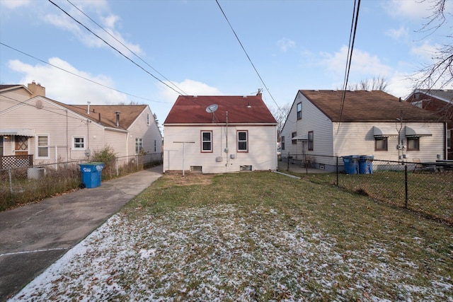 rear view of house featuring a lawn