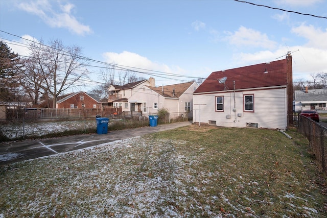 rear view of property featuring a yard