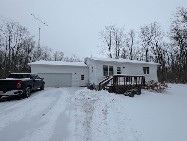 manufactured / mobile home with a garage and a wooden deck