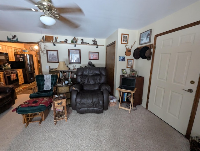 living room with ceiling fan and carpet flooring