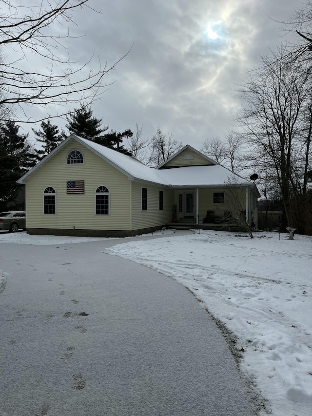 view of snow covered rear of property