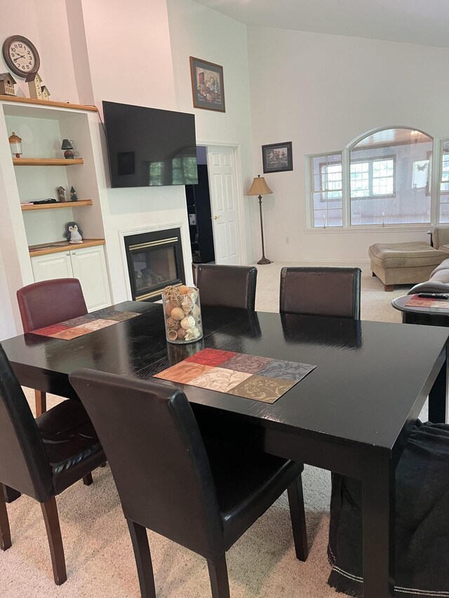 2273 Woodland Trl, Hillsdale, MI 49242 - dining area featuring carpet flooring and a glass covered fireplace