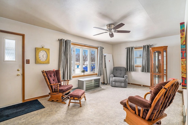 living area featuring ceiling fan and carpet