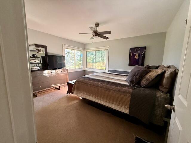 carpeted bedroom with ceiling fan