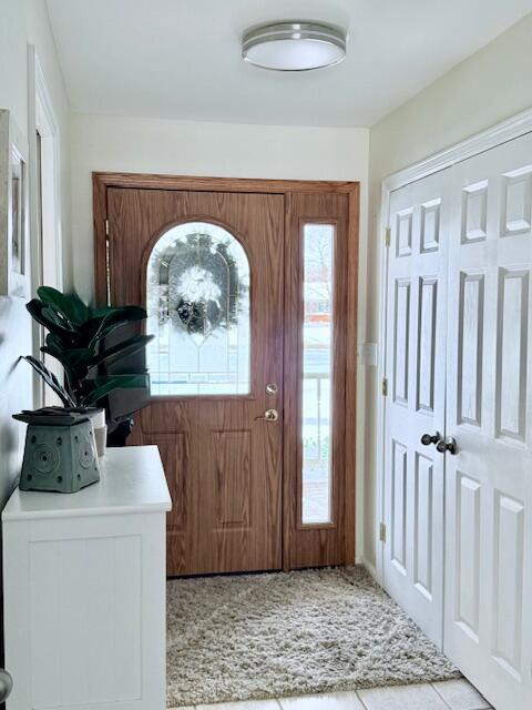 foyer entrance with light tile patterned floors