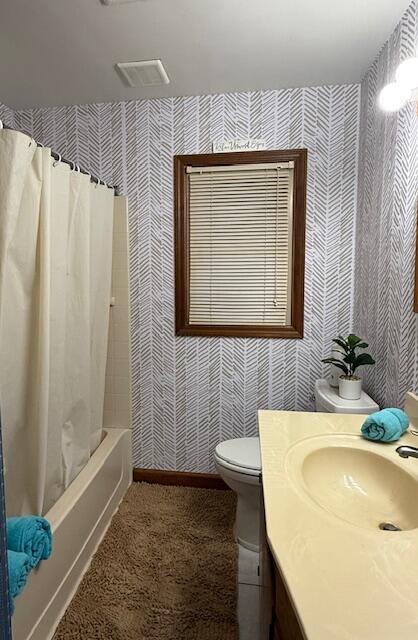 full bathroom featuring toilet, vanity, and shower / bath combo with shower curtain