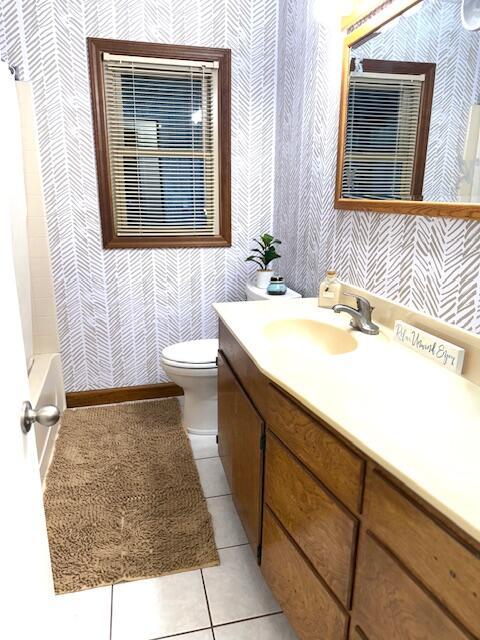 bathroom featuring toilet, vanity, and tile patterned floors