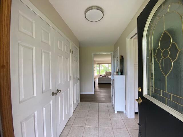 hall with light tile patterned floors