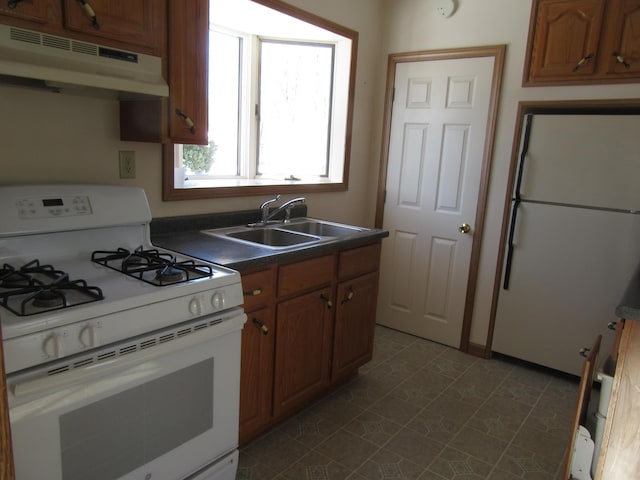 kitchen with sink and white appliances