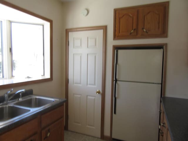 kitchen featuring white fridge and sink