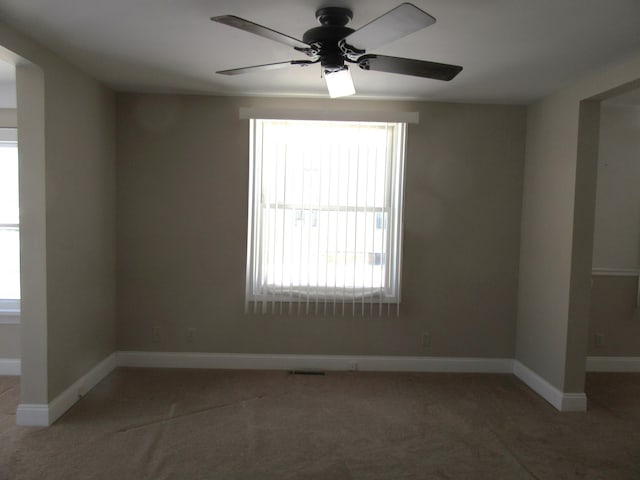 empty room featuring ceiling fan and carpet flooring