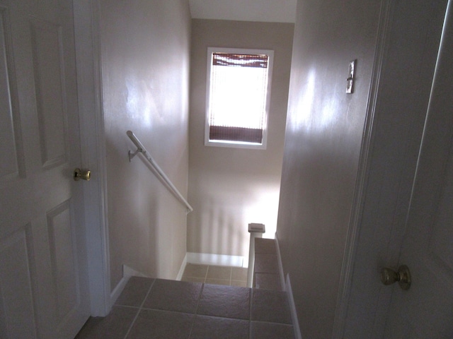 stairs featuring tile patterned flooring