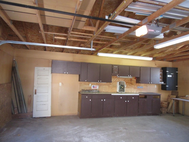 garage with a workshop area and a garage door opener