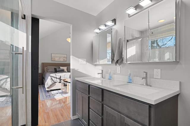 bathroom with vanity, wood-type flooring, and a shower with door