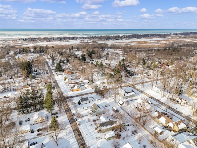 snowy aerial view featuring a water view