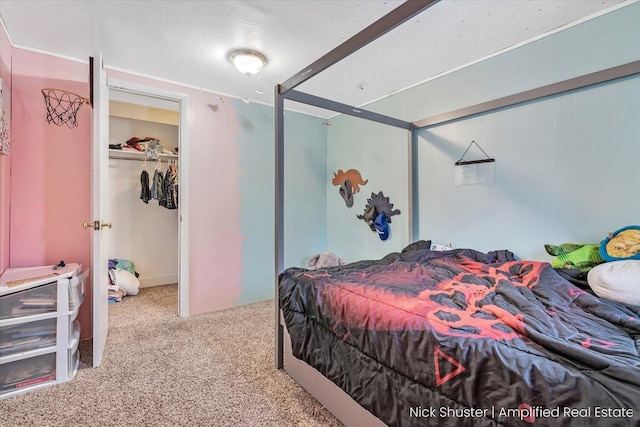 bedroom with a closet and light carpet