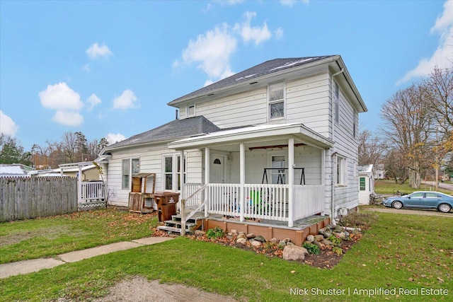 view of front of house featuring a front lawn and covered porch