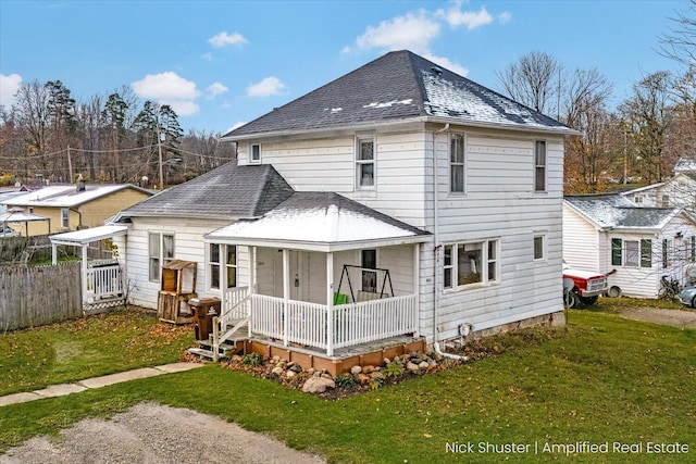 back of house with a porch and a yard