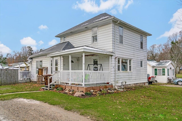 view of front of home with a porch and a front lawn