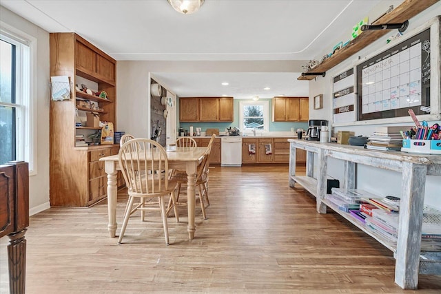 dining room with light wood-style flooring and recessed lighting