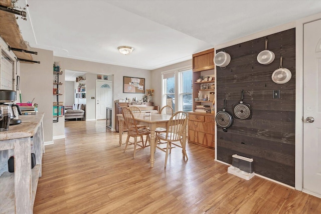 dining area featuring light wood finished floors and a barn door