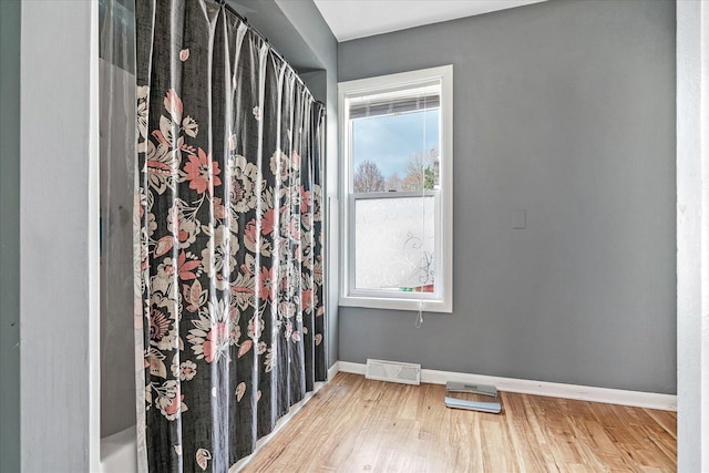 unfurnished room with wood finished floors and baseboards