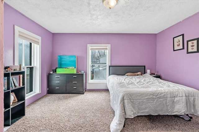 bedroom featuring carpet floors and a textured ceiling