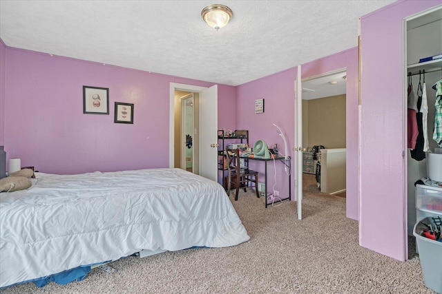 bedroom featuring carpet floors and a textured ceiling