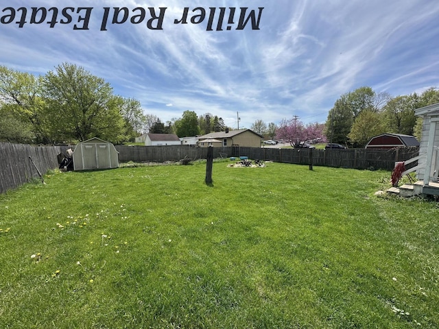 view of yard featuring a storage shed and an outbuilding