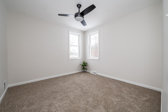 unfurnished room featuring ceiling fan and carpet floors