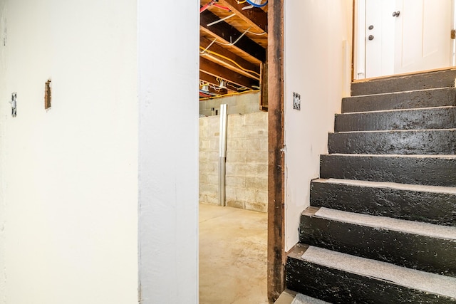 staircase with concrete flooring