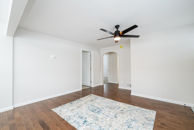 spare room featuring ceiling fan and dark hardwood / wood-style floors