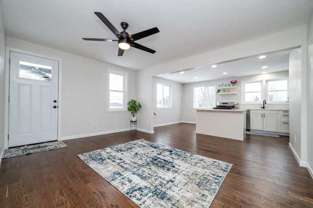 foyer featuring ceiling fan, a healthy amount of sunlight, and dark hardwood / wood-style floors