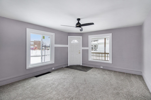 spare room featuring ceiling fan, a wealth of natural light, and carpet floors