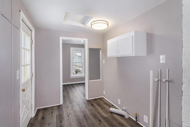 laundry room with cabinets, dark hardwood / wood-style flooring, and gas dryer hookup