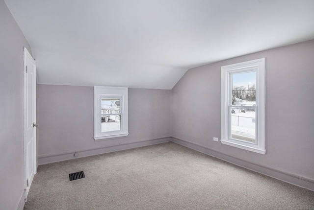 bonus room featuring vaulted ceiling and carpet floors