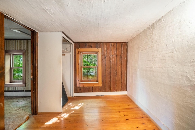 unfurnished room with wood-type flooring